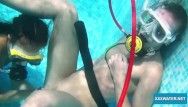 Lesbians underwater giving a kiss and licking